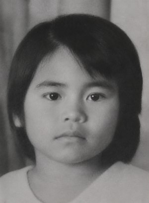 Kung Fu Hand Painting - A restored black-and-white close-up portrait of a young child facing forward with a calm, serious expression. The image has soft vintage lighting, smooth grayscale tones, dark straight hair framing the face, clear eyes, and a simple blurred background. The repaired photo preserves an old studio-style, nostalgic feeling.