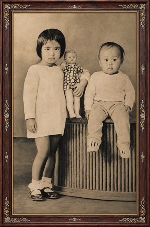 Kung Fu Hand Painting - A beautifully restored sepia portrait captures two young children in a timeless studio pose. The rosewood frame, with gold inlay and ornate completed corners, adds antique elegance. Soft tones, crisp details, knitted clothing, flowers, and calm expressions create a cherished family keepsake full of warmth, history, and gentle nostalgic beauty.
